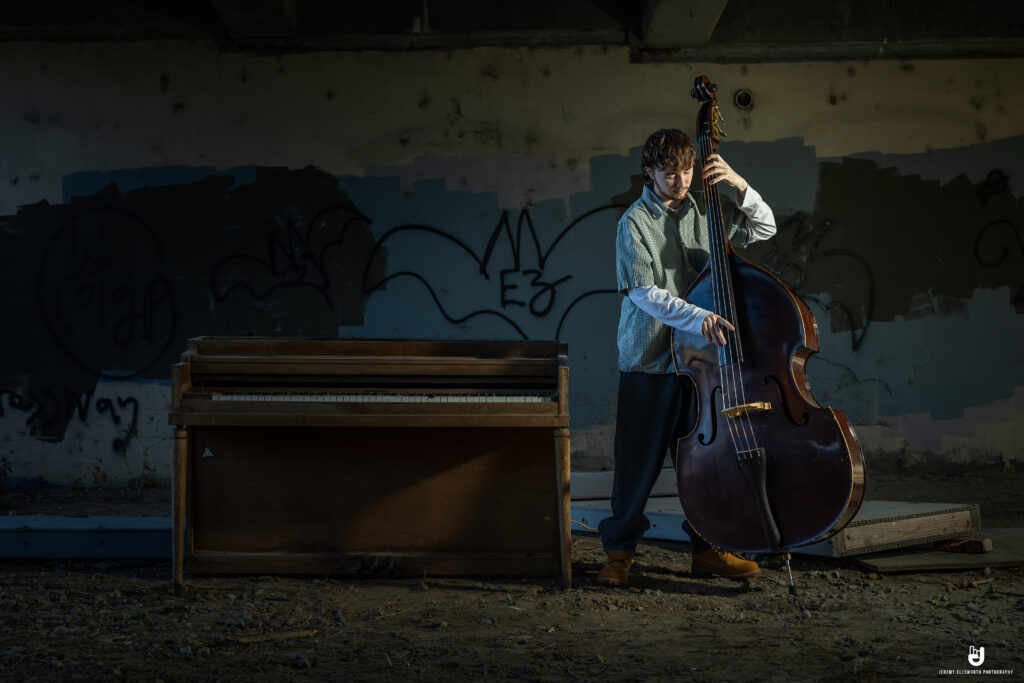 Senior picture by Kansas City senior photographer Jeremy Ellsworth featuring a bold urban backdrop.